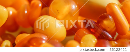 Sunny beads of fire amber. Natural gemstone background, jewelry concept Sunny beads of fire amber. Natural gemstone background, jewelry concept 86122421