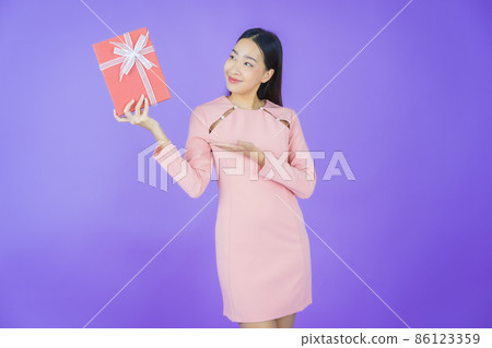 Portrait beautiful young asian woman smile with red gift box Portrait beautiful young asian woman smile with red gift box 86123359
