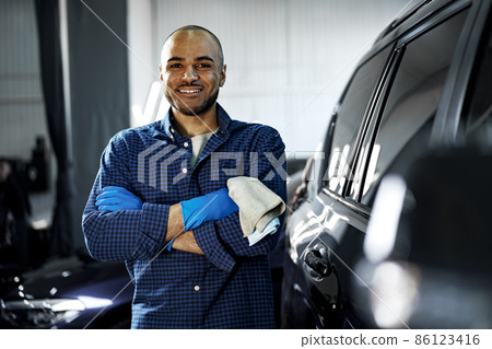 Portrait of African American man, car wash detailing service worker 86123416