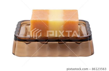 New soap on a dish isolated on white background New soap on a dish isolated on white background 86123563