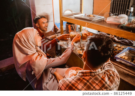 muslim asian friend cheering their glass for break fasting 86125449