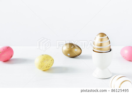 Colorful Easter eggs on white wooden table over white background. Colorful Easter eggs on white wooden table over white background. 86125495