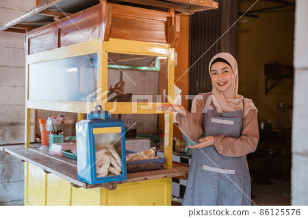 proud muslim woman with her small food stall 86125576