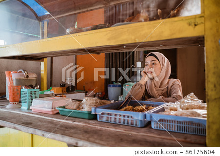 frustrated Young muslim entrepreneurs at her empty shop frustrated Young muslim entrepreneurs at her empty shop 86125604