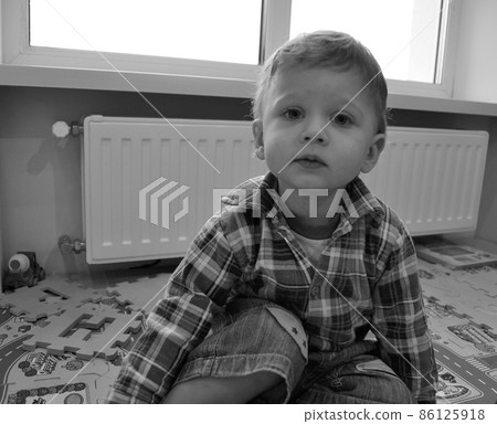 Beautiful baby boy with child face posing photographer Beautiful baby boy with child face posing photographer 86125918