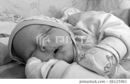 Beautiful sleeping baby boy with child hat posing photographer 86125961