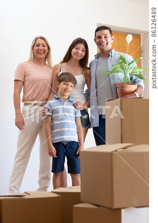 Portrait of pleased family in new house Portrait of pleased family in new house 86126489