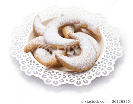 Traditional German or Austrian Vanillekipferl vanilla kipferl cookies on a plate isolated on white background 86126550