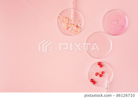 Abstract petri dishes with organic natural cosmetic on pink background top view. Science cosmetic laboratory concept. 86126710