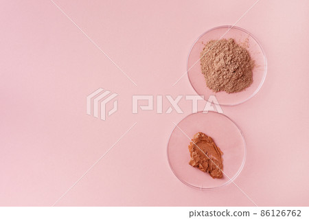 Dry facial red clay powder in petri dishes top view. Natural organic cosmetic clay for beauty treatment. Laboratory equipment and cosmetic ingredients. 86126762