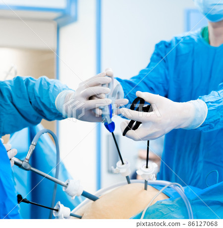 Hands of surgeons with surgical equipment. Hands of surgeons with surgical equipment. 86127068
