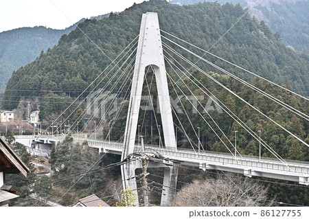 Tokyo Okutama A modern suspension bridge that straddles the Mitake Gorge View from Kori Station on the Ome Line Mountains in Okutama 86127755