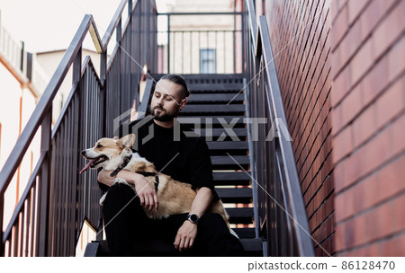 guy with corgi 86128470