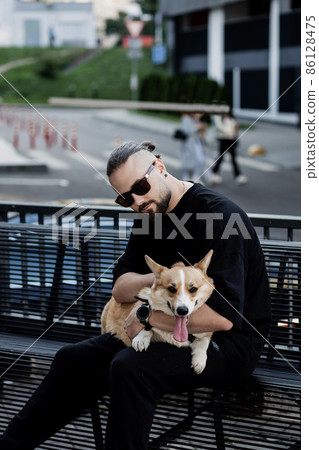 man holding welsh corgi dog man holding welsh corgi dog 86128475