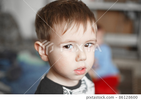 Little Caucasian boy looking at camera, lifestyle photography Little Caucasian boy looking at camera, lifestyle photography 86128600