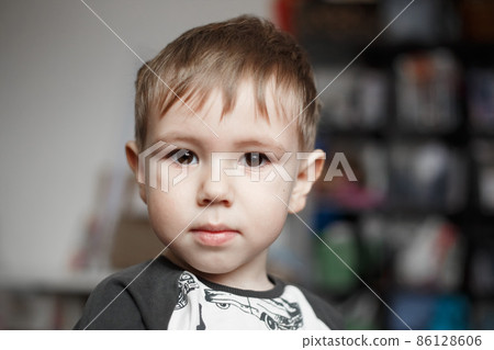 Little Caucasian boy looking at camera, lifestyle photography Little Caucasian boy looking at camera, lifestyle photography 86128606
