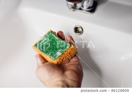 cleaning the bathroom sink 86128609