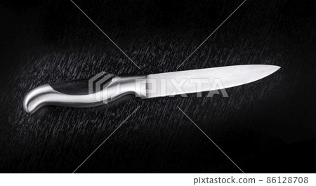 Kitchen knife on black wooden table. Selective focus 86128708