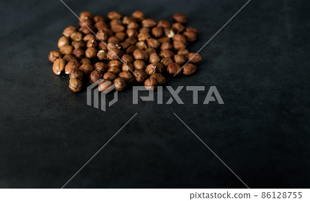 Many hazelnuts on dark backdrop Many hazelnuts on dark backdrop 86128755