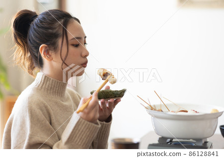 Cute woman eating oden Cute woman eating oden 86128841