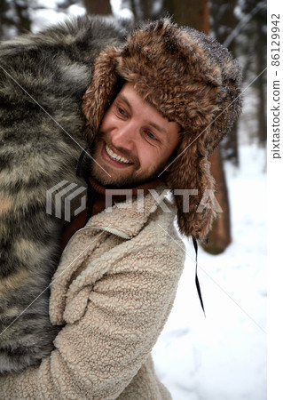 Men playing with siberian husky in winter forest and park, animals and ecology. Pet lover. Dog - human s friend concept 86129942