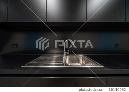 At the bottom of the cupboard of a modern kitchen 86130962