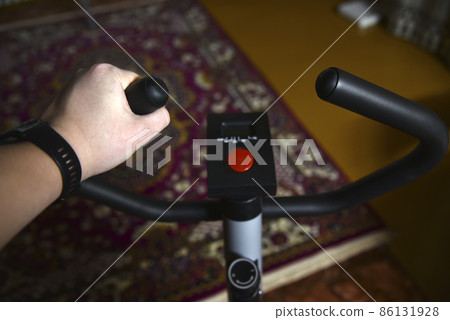Exercise bike at home in the evening Exercise bike at home in the evening 86131928