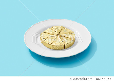 Processed cheese on the plate over blue background with deep long shadows. Minimal creative food concept 86134037
