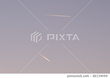 Distant passenger jet plane flying on high altitude on clear blue sky leaving white smoke trace of contrail behind. Air transportation concept 86134049