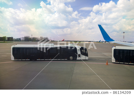 Airplane wing and special bus for moving passengers from aircraft to terminal. Airplane wing and special bus for moving passengers from aircraft to terminal. 86134209