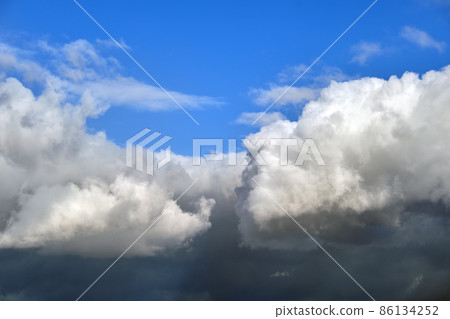 Bright landscape of white puffy cumulus clouds on blue clear sky 86134252