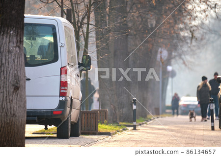 Close up of a van parked illegally against traffic rules on pedestrian city street side Close up of a van parked illegally against traffic rules on pedestrian city street side 86134657