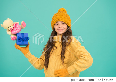 Good time. small kid in warm clothes hold gifts. winter 86135066