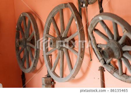 Old wooden wheels of coach ready for repair Old wooden wheels of coach ready for repair 86135465