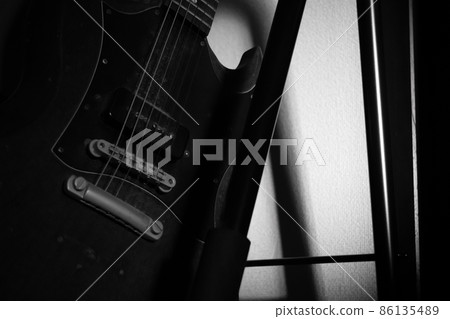 Monochrome photo of a dusty guitar Monochrome photo of a dusty guitar 86135489