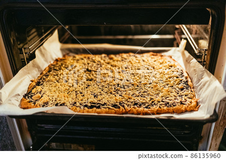 Delicious homemade pie in oven 86135960