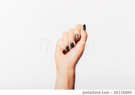 Female hand with dark manicure 86136066