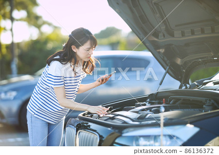 年輕女子因汽車故障打電話 年輕女子因汽車故障打電話 86136372