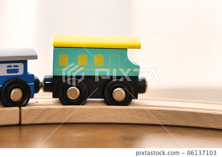 A cute toy locomotive running on the rails A cute toy locomotive running on the rails 86137103