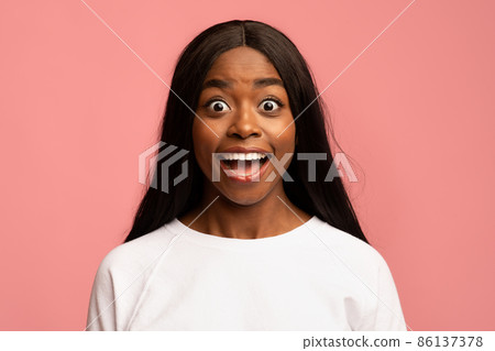 Surprised black lady looking at camera, closeup shot Surprised black lady looking at camera, closeup shot 86137378