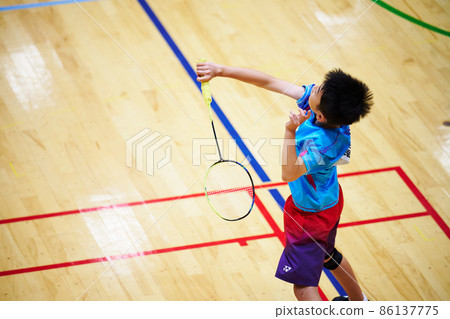 Elementary school boys playing badminton games Elementary school boys playing badminton games 86137775