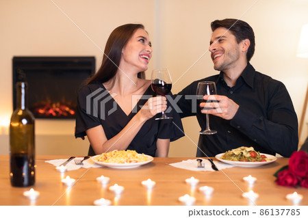 Happy woman and man drinking wine on festive date 86137785