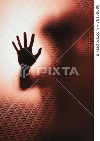 Behind glass door a leaning woman's hand asks for help 86138080