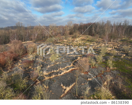Dump toxic waste soil wood tree penetration former chemical plant black coke factory aerial drone video shot view now extremely contaminated pollution asphalt area Orlova Lazy 1899 to 1967 asphalted Dump toxic waste soil wood tree penetration former chemical plant black coke factory aerial drone video shot view now extremely contaminated pollution asphalt area Orlova Lazy 1899 to 1967 asphalted 86138390