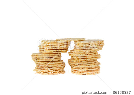 Stacks of dry round cornbread isolated on white background. Stacks of dry round cornbread isolated on white background. 86138527