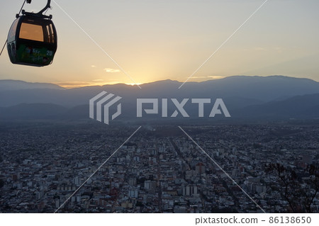 panoramic of Salta, Argentina, and cablecar cabin above. sunset, cityscape buildings panoramic of Salta, Argentina, and cablecar cabin above. sunset, cityscape buildings 86138650