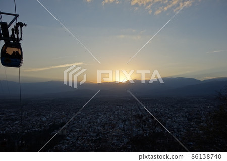 panoramic of Salta, Argentina, and cablecar cabin above. sunset, cityscape buildings panoramic of Salta, Argentina, and cablecar cabin above. sunset, cityscape buildings 86138740