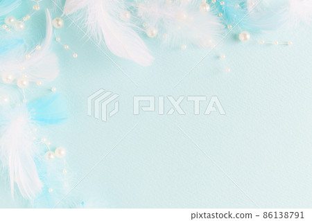 Light blue background with white feathers and blue feathers and pearls Light blue background with white feathers and blue feathers and pearls 86138791
