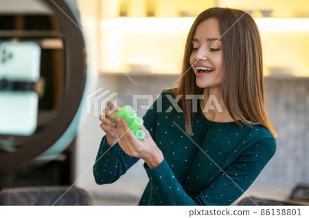 Smiling young woman showing tips on hairstying with curlers 86138801