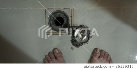 Drain cleaning. Clogged and dirty sewer pipes floor drain. Full of hair and accumulated clogged grease. Maintenance the floor drain sewage system in bathroom. fixing clean wash and unclog a drain. Drain cleaning. Clogged and dirty sewer pipes floor drain. Full of hair and accumulated clogged grease. Maintenance the floor drain sewage system in bathroom. fixing clean wash and unclog a drain. 86139315